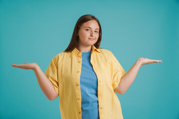 Young white woman wearing shirt smiling while holding copyspace