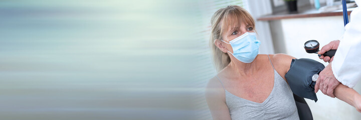 Blood pressure measurement of a female patient; panoramic banner