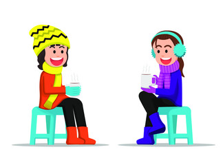 Two little girls chatting together while holding a hot drink
