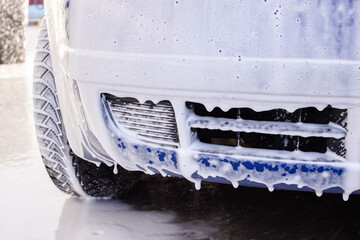 Blue car in foam at a car wash