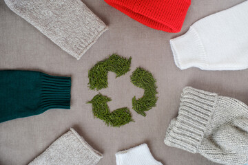 Recycling sign with Christmas tree needles. Winter recycling clothes. Top view or flat lay. High...