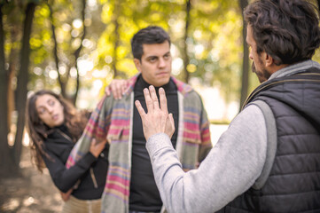 Two aggressive men in quarrel and woman. Finger pointing