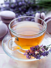 Cup of tea with macaroon dessert with lavender flavor