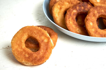 Fried curd donuts in a blue plate close up