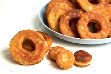 Fried curd donuts in a blue plate close up
