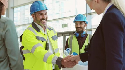 Mature architect and contractor shaking hands at construction site - Powered by Adobe