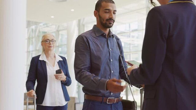 Happy mixed race man showing electronic flight ticket