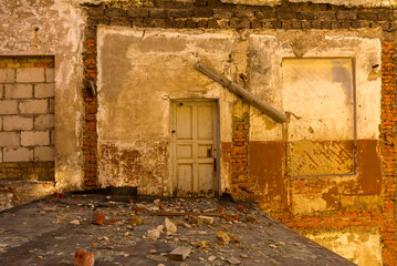 Door in a ruined house, inside view 