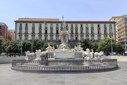 The Neptune fountain in Municipio square of Naples. On Background San Giacomo palace, seat of the municipality of Naples, Campania, Italy