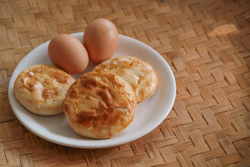 stack of round bread decorated with eggs