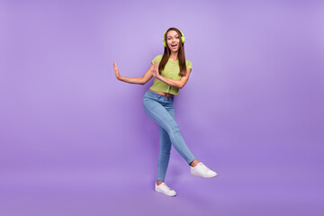 Fototapeta na wymiar Full length body size view of pretty cheerful girl listening rock melody dancing isolated over purple violet color background