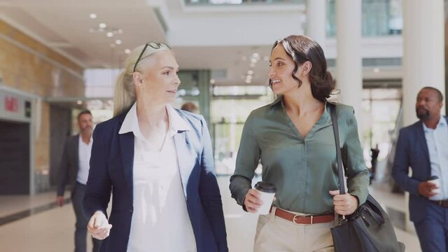 Businesswomen walking in corporate building