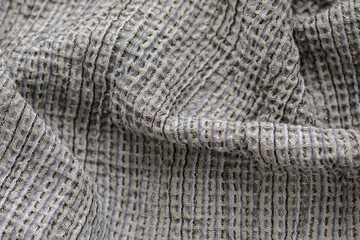 Fototapeta premium Organic waffle linen towels, bamboo toothbrushes, bathroom zero waste accessories in grey shades in contemporary bathroom interior. Daily body care, spa and wellness zero waste bathroom concept