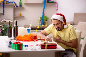 Young man cleaning the apartment after Christmas party