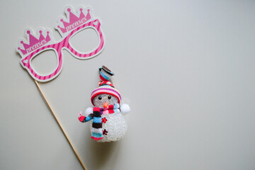 pink girl queen eye mask with new year's preparation and snowman toy