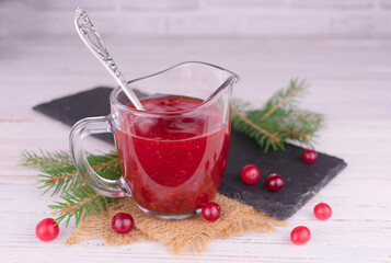 Cranberry sauce in a glass gravy boat.