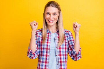 Photo of hooray blond millennial lady hands fists wear plaid shirt isolated on yellow color background