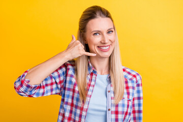 Photo of funky blond young lady hand telephone wear plaid shirt isolated on yellow color background