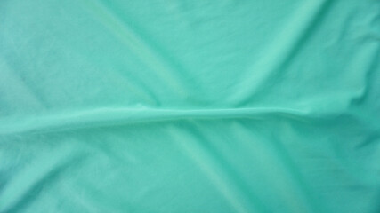 Abstract green fabric texture for backgrounds or other design illustrations.