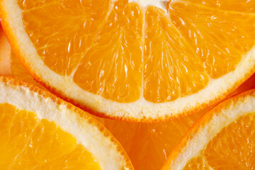 Fototapeta na wymiar Fresh juicy orange slices closeup top view. Tropical citrus fruits texture background.
