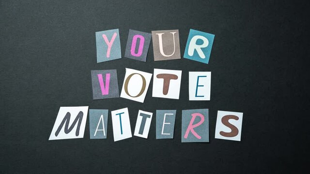 Your vote matters words. Caption, heading made of letters with different fonts on a dark background.