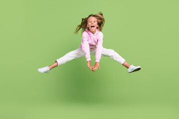 Full length photo of funky small blond girl jump wear sweatshirt trousers sneakers isolated on...