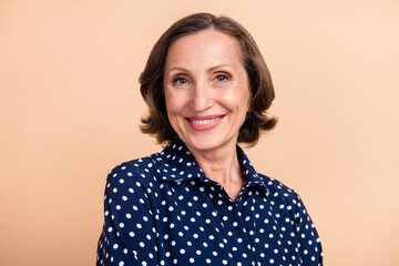 Photo of nice aged brunette lady wear blue shirt isolated on beige color background