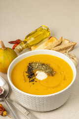 Pumpkin cream soup. Traditional autumn food. Hot dish, ripe vegetables, fragrant spices