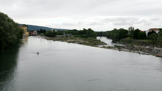 Wonderful landscape rower trains in Ivrea's dora river. Panning 4K