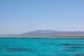 Red sea landscape with clear blue water and mountains and clear sky