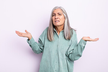 middle age gray hair woman looking puzzled, confused and stressed, wondering between different...