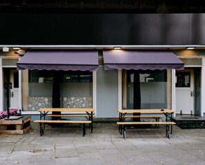closed restaurant in the urban city with purple sunblinds, concept photo to show the impact of the coronavirus in Germany respectively the retail industry.