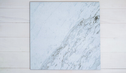 Marble tiles on a white wooden background.