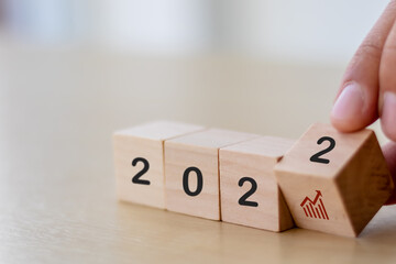 Business growth concept in 2022  for business plan and strategy. Hand flips wooden cubes  2022 and ...