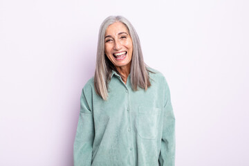 middle age gray hair woman with a big, friendly, carefree smile, looking positive, relaxed and...