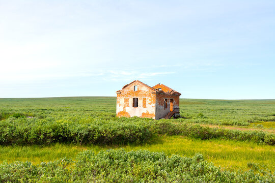 Lonely ruined house in the green Tundra