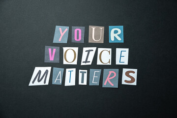 Your voice matters words. Caption, heading made of letters with different fonts on a dark...