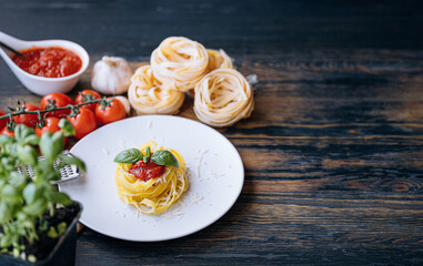 italian pasta bolognese with grated parmesan and basil close-up ingredients in the background