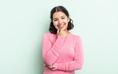 pretty teenager woman smiling, enjoying life, feeling happy, friendly, satisfied and carefree with...