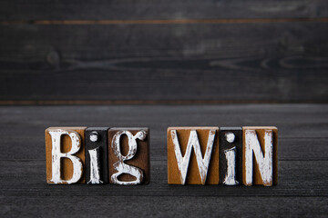 Big Win. Text on a dark wooden background
