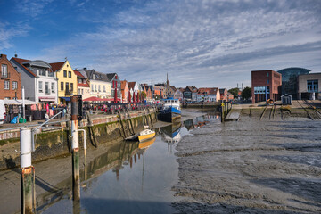 Husum harbor at ebb tide in the marshes, Germany