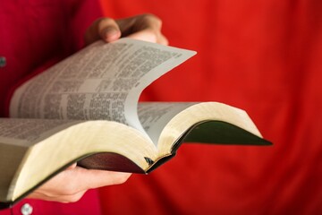 Closeup on a Man Holding a Bible