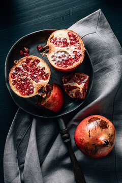 Ripe pomegranate on pan on table