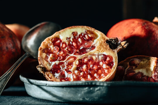Ripe pomegranate on pan on table