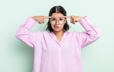 pretty teenager woman with a serious and concentrated look, brainstorming and thinking about a...