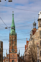 Obraz premium A view of a lutheran church in Riga which is obstructed with cables and wires symbolizing the outside world interfering with our spirituality