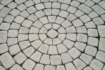 The tiles are laid out in a circle, geometric symmetrical masonry stone