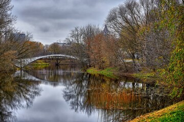 Autumn park on the river with a bridge