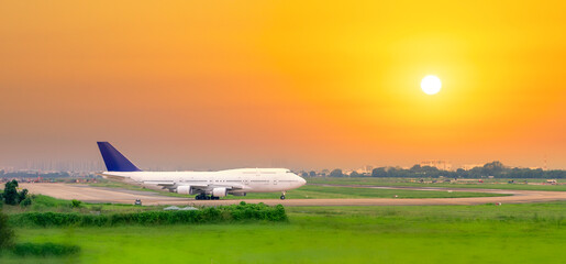 Cargo plane landing at Tan Son Nhat International Airport with sunset sky background, Ho Chi Minh...