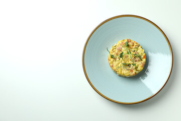 Plate with Olivier salad on white background